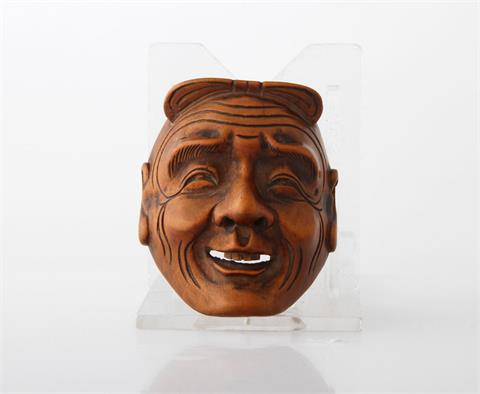 Feines Netsuke einer Maske aus Holz. JAPAN, 1. Hälfte 20. Jh.
