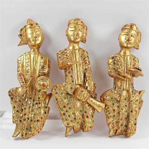 Gruppe von drei dekorativen Figuren aus Holz. THAILAND, 20. Jh.